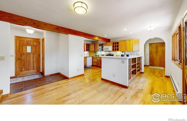 kitchen with white appliances, arched walkways, beamed ceiling, a baseboard heating unit, and open shelves