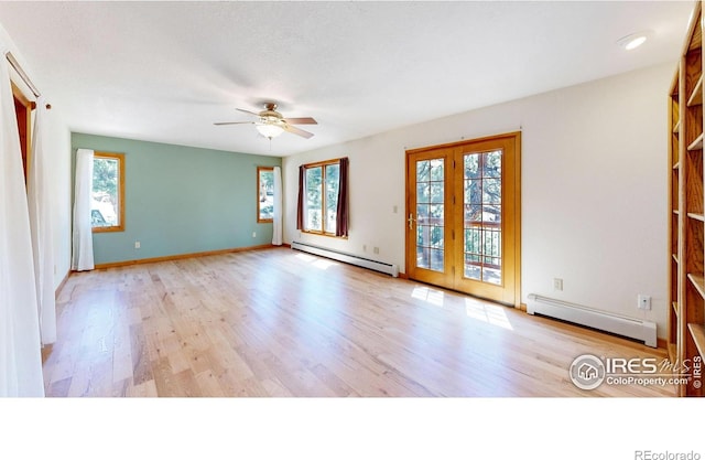 spare room with a baseboard radiator and wood finished floors