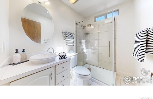 full bathroom featuring a stall shower, tile patterned flooring, vanity, and toilet