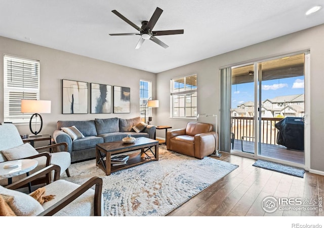 living area featuring a ceiling fan and wood finished floors