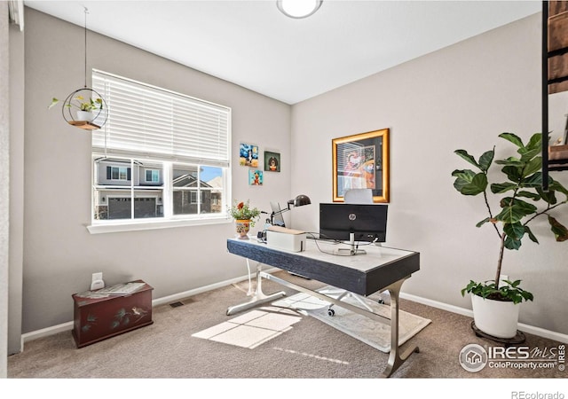 carpeted home office featuring visible vents and baseboards