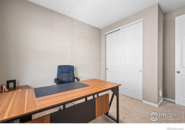 office with carpet flooring, vaulted ceiling, and baseboards