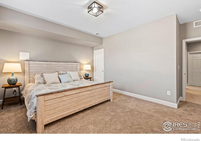 carpeted bedroom featuring baseboards