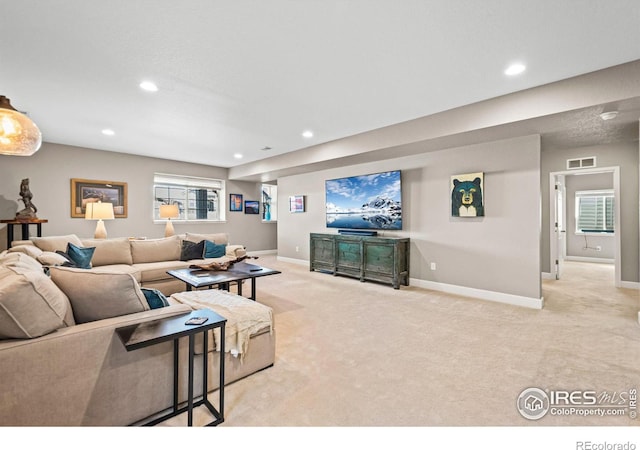 living area featuring carpet floors, recessed lighting, visible vents, and baseboards