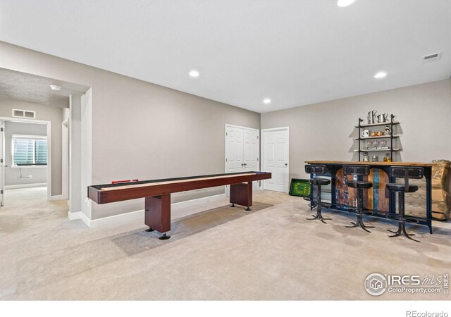 playroom featuring carpet floors, recessed lighting, visible vents, and a dry bar