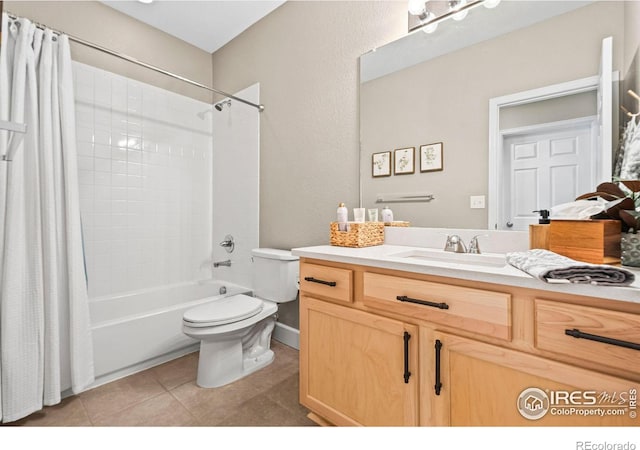 full bath with shower / bath combo, vanity, toilet, and tile patterned floors