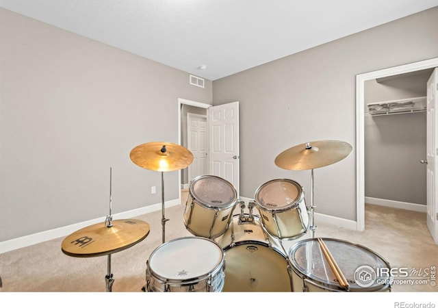 interior space featuring carpet flooring, visible vents, and baseboards