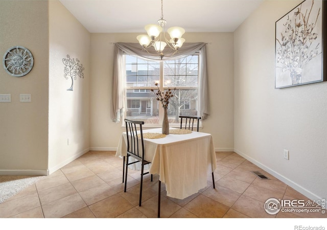 dining area featuring baseboards, light tile patterned floors, visible vents, and an inviting chandelier