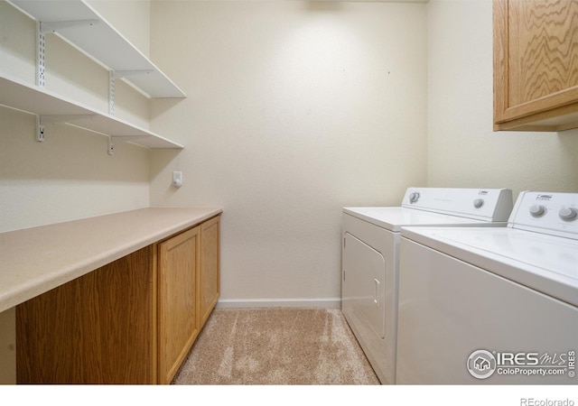 laundry room with washer and dryer, light carpet, cabinet space, and baseboards