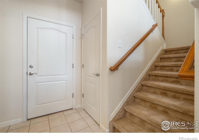 stairway with tile patterned flooring