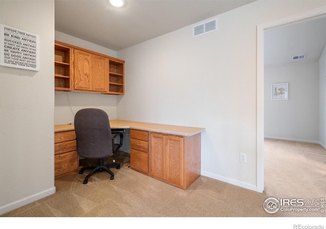 office area with light carpet, visible vents, and baseboards