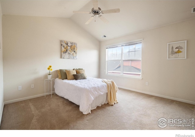 carpeted bedroom with visible vents, vaulted ceiling, and baseboards