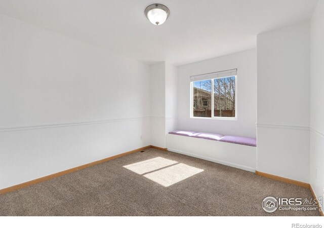 empty room with baseboards and carpet floors