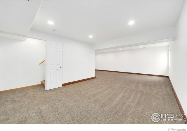 finished below grade area featuring recessed lighting, baseboards, stairs, and carpet