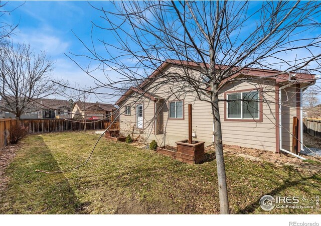 exterior space featuring a yard and fence