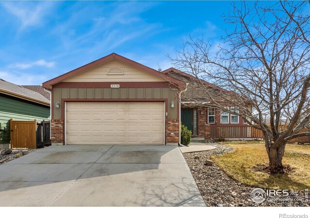 view of front of home with brick siding, driveway, a garage, and board and batten siding