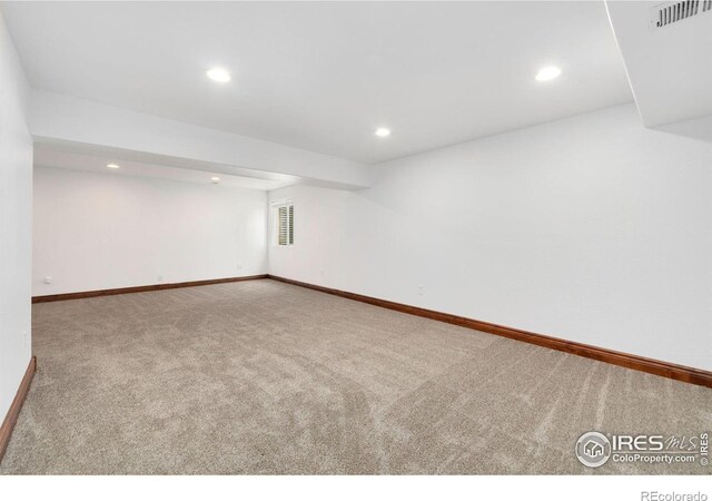 carpeted empty room with visible vents, recessed lighting, and baseboards