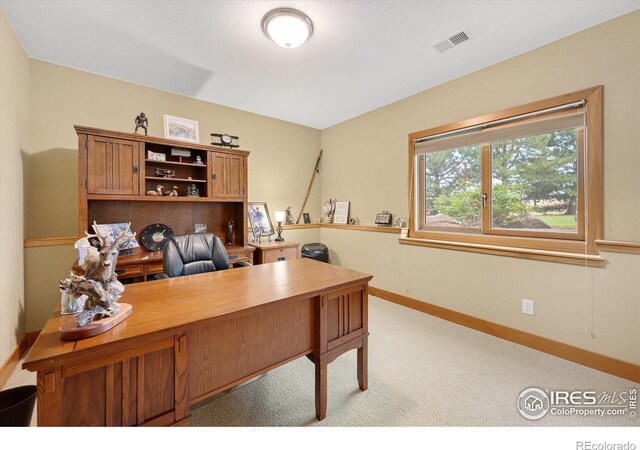 carpeted office with baseboards and visible vents