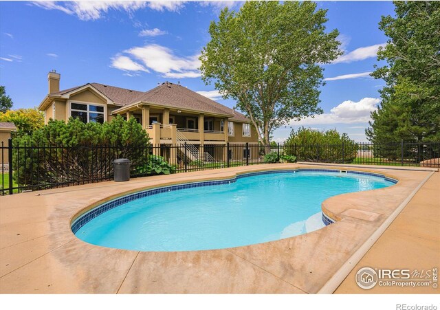 view of swimming pool featuring fence and a fenced in pool