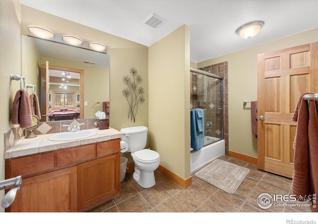 bathroom featuring toilet, vanity, visible vents, and enclosed tub / shower combo