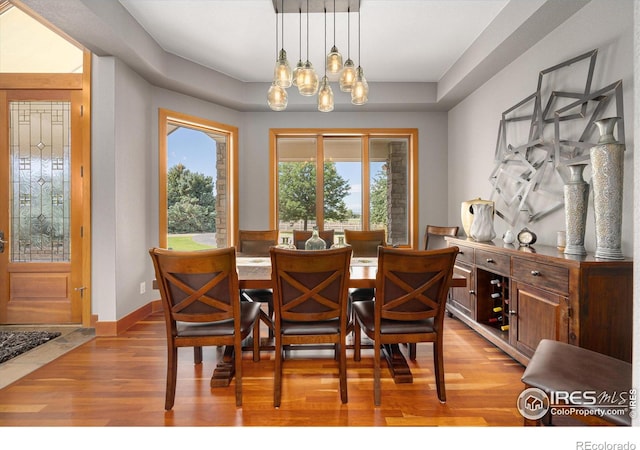 39658 Ridge Park Dr, Severance, CO 80610 - dining room with light wood finished floors, a chandelier, and baseboards
