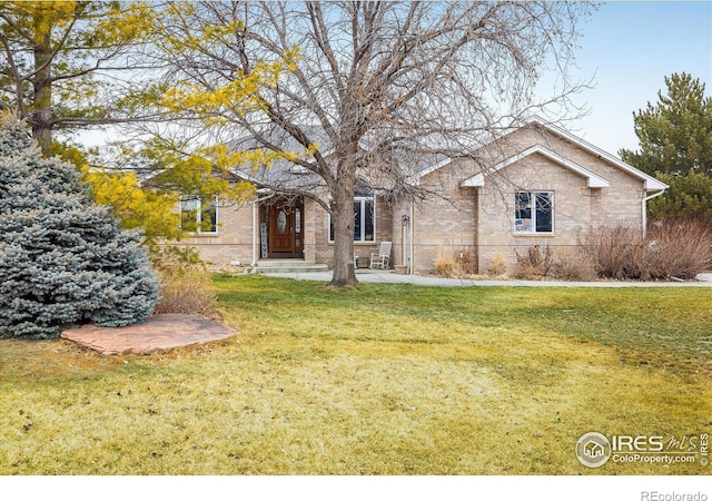 ranch-style home with brick siding and a front yard