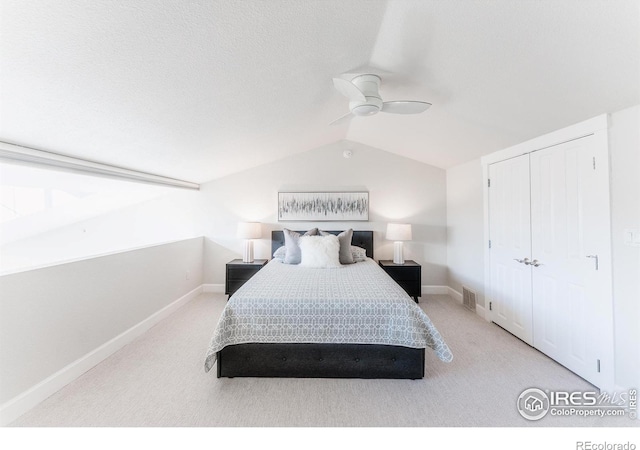 bedroom featuring visible vents, lofted ceiling, ceiling fan, carpet floors, and a closet