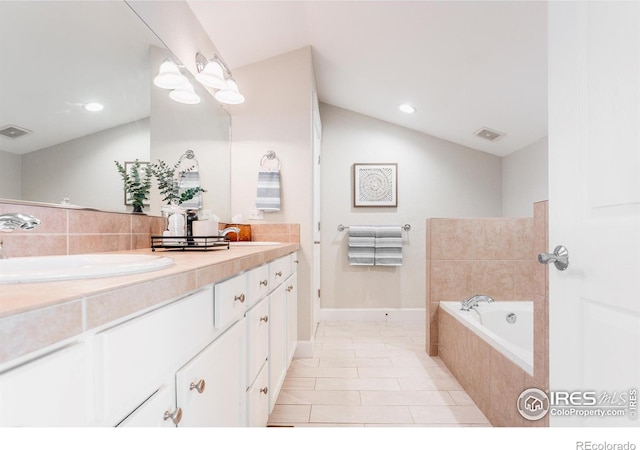 full bath featuring double vanity, lofted ceiling, visible vents, a sink, and a bath