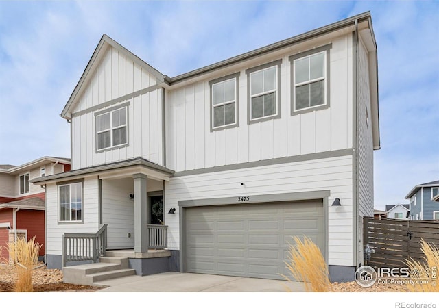 view of front facade featuring an attached garage, fence, and board and batten siding