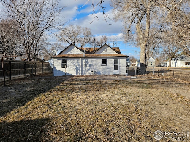 back of house featuring fence private yard and a gate