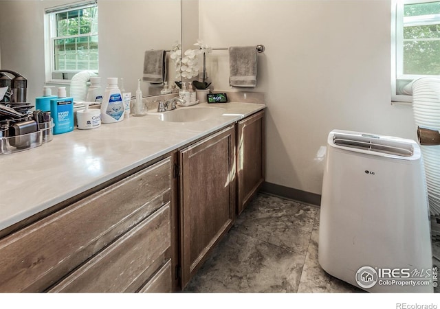 bathroom featuring vanity and baseboards