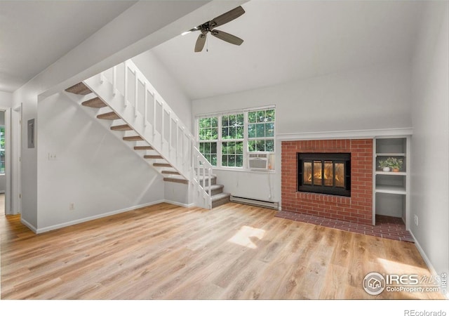 3565 Windmill Dr Unit 5, Fort Collins, CO 80526 - unfurnished living room with a baseboard radiator, wood finished floors, stairs, ceiling fan, and high vaulted ceiling