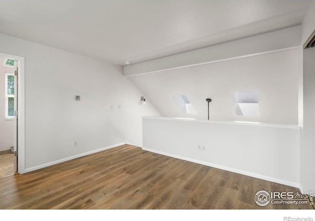 3565 Windmill Dr Unit 5, Fort Collins, CO 80526 - unfurnished room with wood finished floors, lofted ceiling, and baseboards