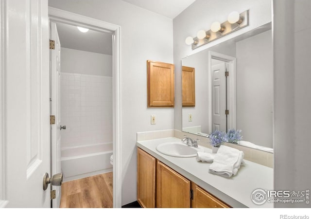 3565 Windmill Dr Unit 5, Fort Collins, CO 80526 - bathroom featuring vanity, toilet, and wood finished floors