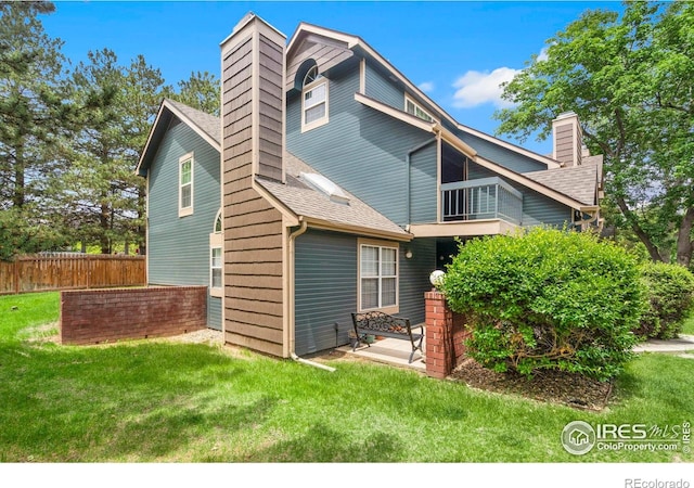 3565 Windmill Dr Unit 5, Fort Collins, CO 80526 - back of property with a chimney and roof with shingles