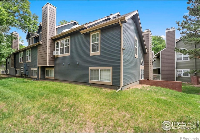 3565 Windmill Dr Unit 5, Fort Collins, CO 80526 - rear view of house with a lawn and a chimney