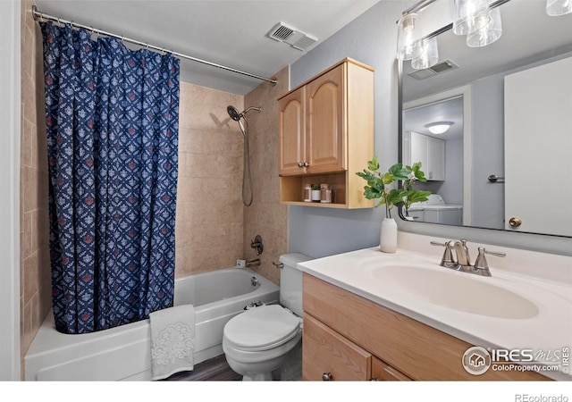 full bathroom with toilet, shower / tub combo, vanity, and visible vents