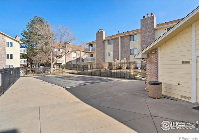 view of swimming pool featuring fence and a residential view