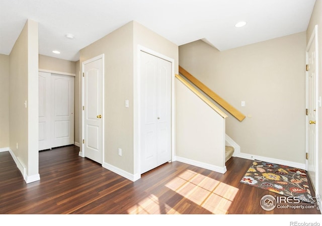 foyer entrance featuring stairway, recessed lighting, wood finished floors, and baseboards