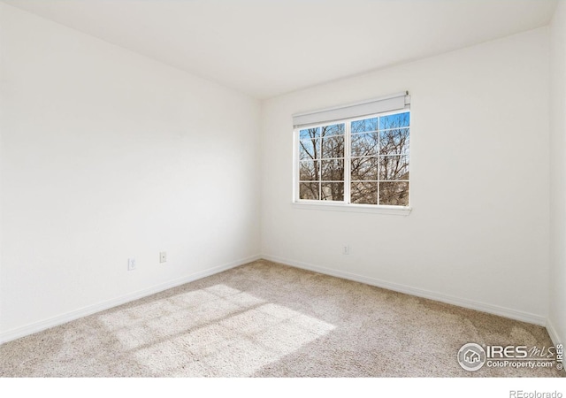 unfurnished room featuring carpet floors and baseboards