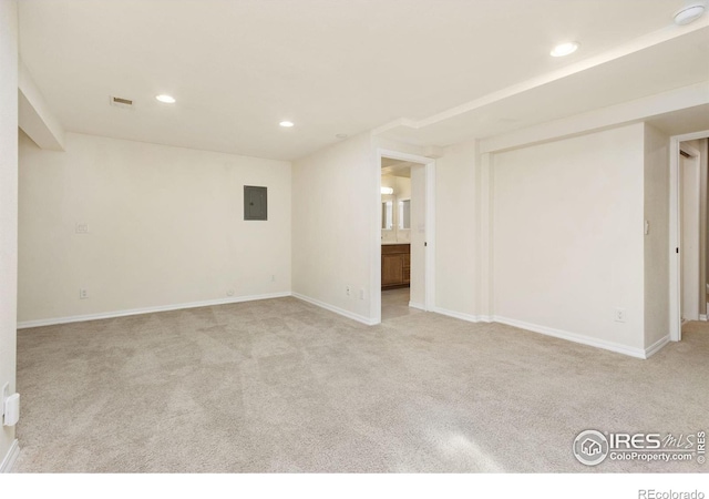 carpeted empty room featuring visible vents, baseboards, electric panel, and recessed lighting