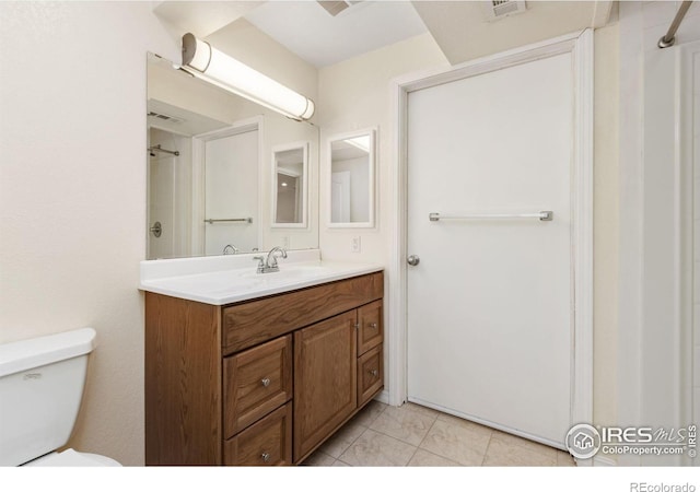 bathroom featuring visible vents, vanity, and toilet