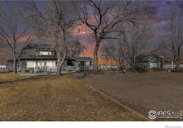 view of front facade featuring a front lawn and covered porch