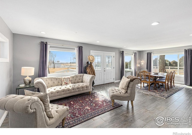 living area with plenty of natural light, recessed lighting, and wood finished floors