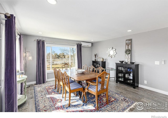 dining room featuring a wall mounted air conditioner, baseboards, wood finished floors, and recessed lighting