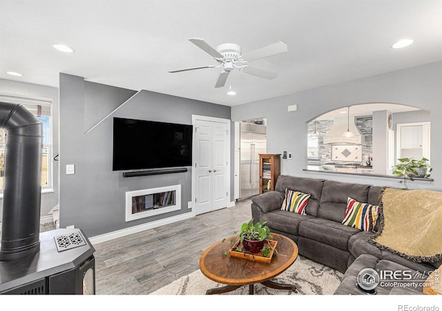 living area featuring recessed lighting, baseboards, a ceiling fan, and wood finished floors