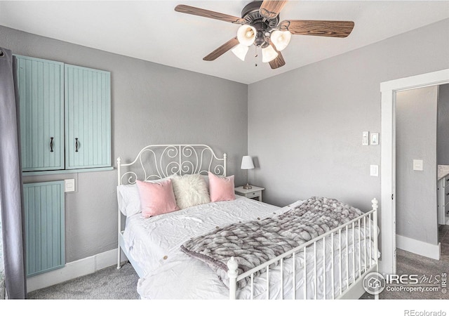 carpeted bedroom featuring a ceiling fan and baseboards