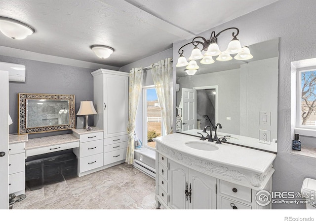 bathroom with a baseboard heating unit, a textured ceiling, a wall unit AC, vanity, and a textured wall