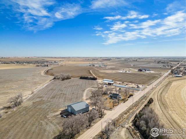 birds eye view of property with a rural view