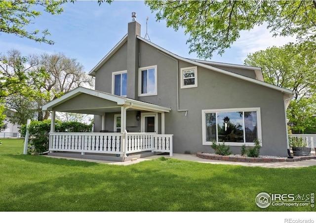 36340 County Road 49, Eaton, CO 80615 - rear view of house with stucco siding, a chimney, a lawn, and a porch